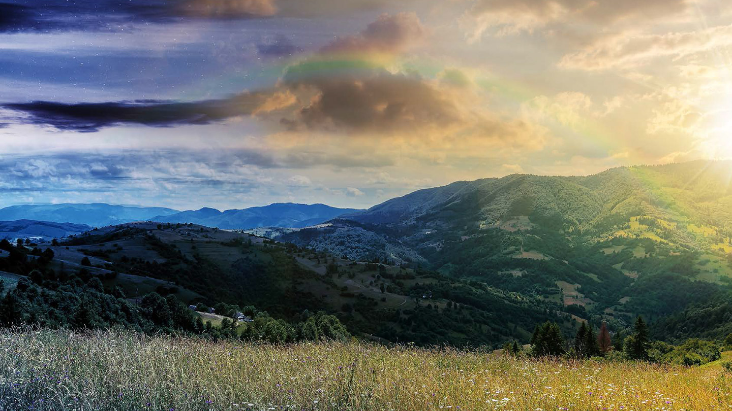 mountainous landscape with faint rainbow