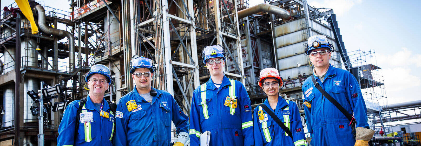 workers at refinery wearing safety clothing and accessories