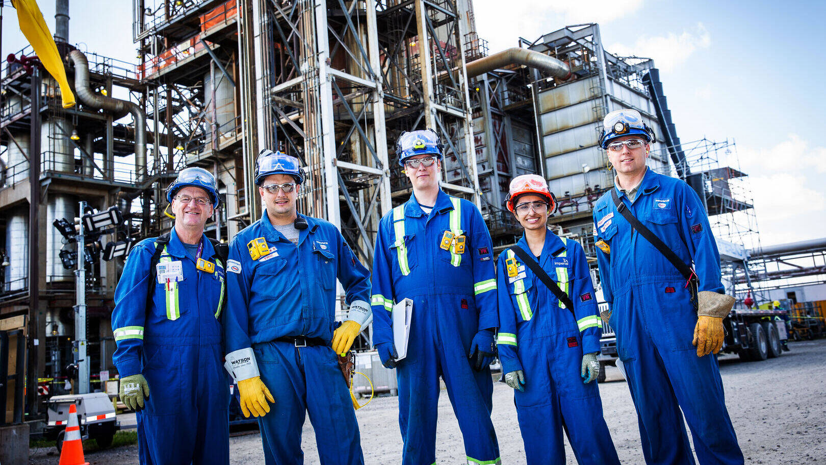 workers at refinery wearing safety clothing and accessories