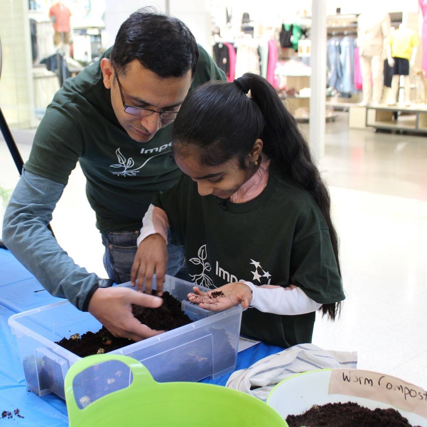 adult and child sifting through compost